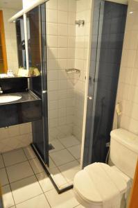 a bathroom with a shower with a toilet and a sink at Rede Andrade Luxor in Teresina