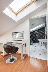 a bathroom with a sink and a stool at Divon Luxury Apartments by Wawel Castle in Krakow