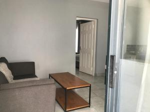 a living room with a couch and a table at Aluve Guesthouse in Johannesburg