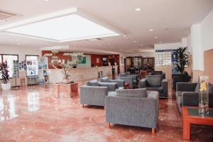 a waiting room with couches and chairs in a lobby at Hotel Playas de Torrevieja in Torrevieja