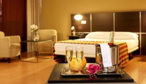 a hotel room with a bed and a table with glasses at La Estación in Benidorm