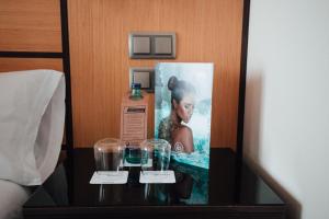 a bottle of alcohol and glasses on a table in a hotel room at Poseidon La Manga Hotel & Spa - Designed for Adults in La Manga del Mar Menor