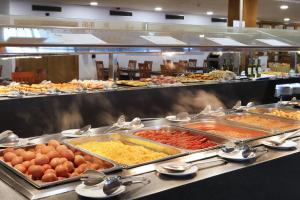 a buffet line with many different types of food at Hotel Poseidon Playa in Benidorm