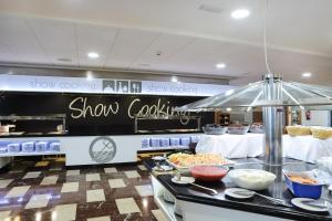 a show cooking area with food on a counter at Hotel Poseidon Playa in Benidorm