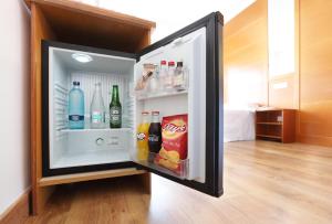 an open refrigerator filled with drinks and drinks at Hotel Poseidon Playa in Benidorm