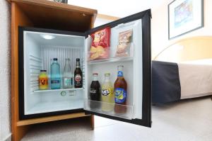an open refrigerator filled with drinks in a room at Hotel Poseidon Playa in Benidorm