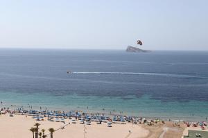 a group of people on a beach flying a kite at Hotel Poseidon Playa in Benidorm