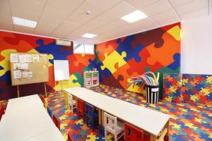 a classroom with colorful walls and desks in a room at Hotel Poseidon Playa in Benidorm