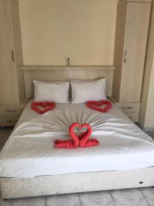 a bed with two red hearts on it at Kahraman Hotel in Side