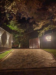 a brick road at night with a gate and lights at Area 4 eco cubes in Ella