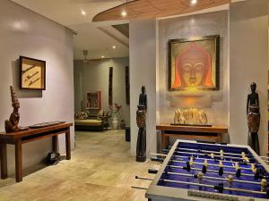 a room with a pool table and a painting on the wall at Aloha Boracay Hotel in Boracay