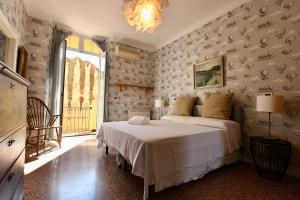 a bedroom with a bed and a large window at Hotel Villa Maria & Apartment in Varazze