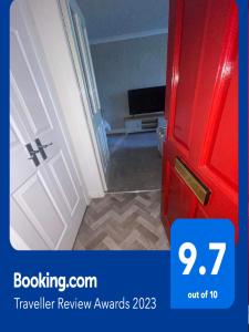 a room with a red door next to a hallway at The Nest, Livingston in Livingston