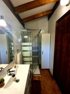 a bathroom with a sink and a shower at Apartamentos & Bungalows Ubiarco El Acebo by Alterhome in Ubiarco