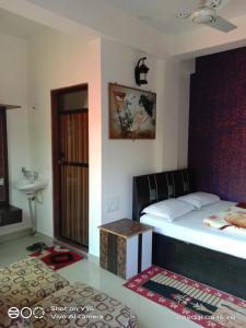 a bedroom with a bed and a sink in it at Om Datta Krupa Niwas Cottage in Mahabaleshwar