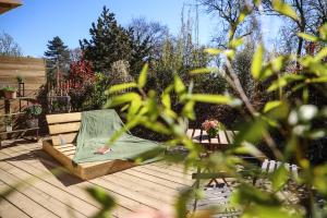 a green tent sitting on a wooden deck at Chalet Nature & Spa in Amayé-sur-Orne