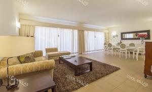 a living room with a couch and a table at Villa Gardenia - sea view, wifi, games room in Albufeira