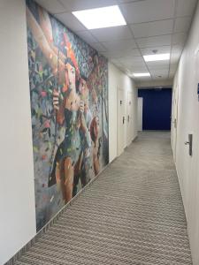 a hallway of an office with a painting on the wall at Optima Collection Nizhyn in Nizhyn