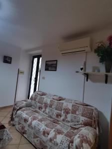 un soggiorno con un divano in una stanza di Hope's corner apartment a Terracina