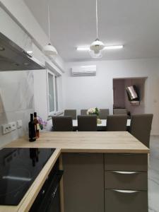 a kitchen with a counter and a table with chairs at Apartment Sea in Supetarska Draga