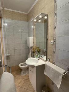 a bathroom with a sink and a toilet and a mirror at Apartment Sea in Supetarska Draga