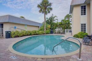 a swimming pool in front of a building at Heat of Siesta Village Walk to Beach w heated Pool in Siesta Key