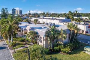 an aerial view of a building with palm trees at Heat of Siesta Village Walk to Beach w heated Pool in Siesta Key