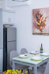 a kitchen with a table with two glasses of wine at Villa Vasso Sea View Residences in Agnítsini
