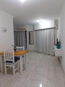 a living room with a wooden table and chairs at Terra Apart in Chivilcoy +5 photos
