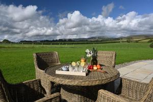 a table with a tray of fruit on a patio at Laverockbank Steading in Buchanty