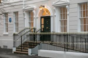 a white house with a black door and stairs at Wilton House in Belfast +75 photos