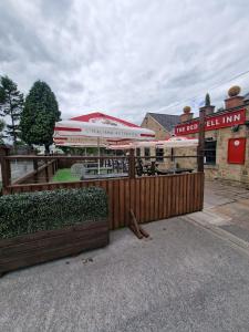 a restaurant with a fence and an umbrella at The Redwell Inn in Barnard Castle