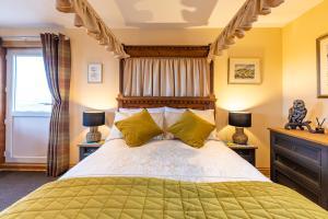 a bedroom with a large bed and two lamps at Vallay Sands in Sollas