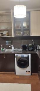 a kitchen with a white stove and a sink at Ivka in Gabrovo +4 photos