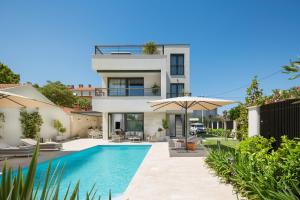 a villa with a swimming pool and a house at Villa Tereza Zadar in Zadar