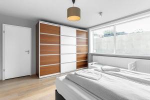 een slaapkamer met een bed en een groot raam bij Central Reykjavík Apartment in Reykjavík