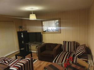 a living room with a couch and a chair at Two Bedroom Apartment, Free parking, Close to UCLAN and free WIFI in Preston