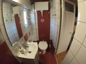 a small bathroom with a toilet and a sink at Harmony in Lávrion