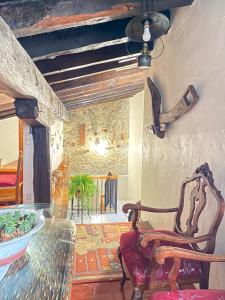 a dining room with a glass table and a chair at Casa Sara in Cantavieja