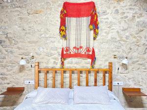 a bedroom with a bed and a wall with a flag at Casa Sara in Cantavieja