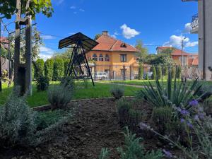 a garden with a playground in front of a house at Casa Topazz in Târgu Jiu