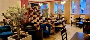 ein Restaurant mit Tischen und Stühlen in einem Zimmer in der Unterkunft Hotel Luise Mannheim - by SuperFly Hotels in Mannheim