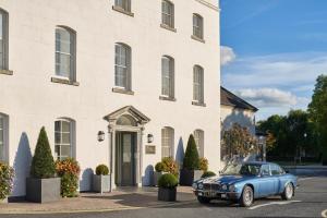 a blue car parked in front of a building at The Johnstown Estate in Enfield