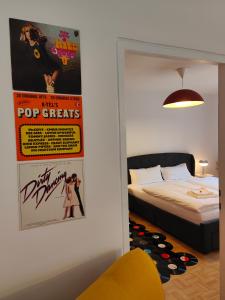 a bedroom with a bed and a poster on the wall at LOLLIPOP - metro to the opera 4 mins away in Vienna