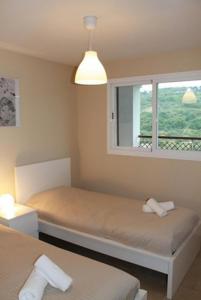 サン・ロケにあるNueva Alcaidesa 2104 - Sea Sun and Greenのベッドルーム1室(ベッド2台、窓付)