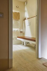 a bathroom with a wooden bench in a room at One Suite in San Marino