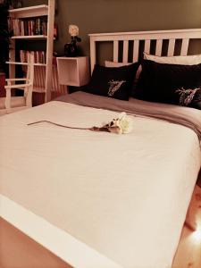 a large white bed with a white flower on it at la belle evasion Paris in Paris