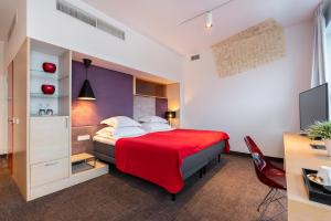 Postel nebo postele na pokoji v ubytování Art Hotel Pallas by Tartuhotels