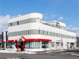 a large white building with a red trim at HOTEL SHAROUM INN - Vacation STAY 04975v in Hakodate