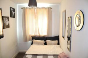 a small room with a bed in front of a window at Two Bedroom Apartment, Free parking, Close to UCLAN and free WIFI in Preston